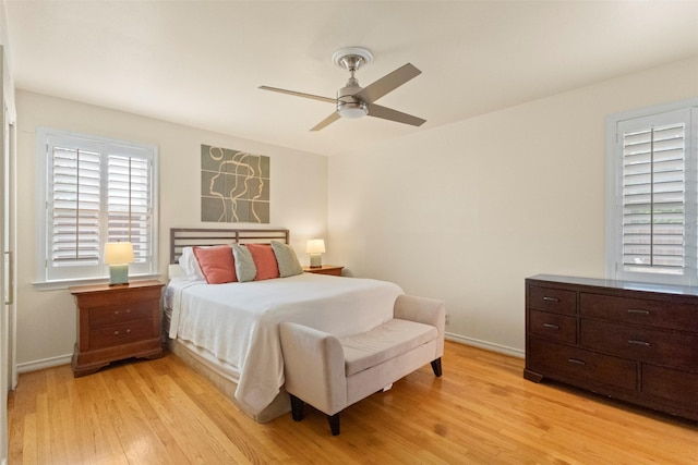 10209 Solta Dr, Dallas, TX 75218 - bedroom with light wood-style floors, a ceiling fan, and baseboards