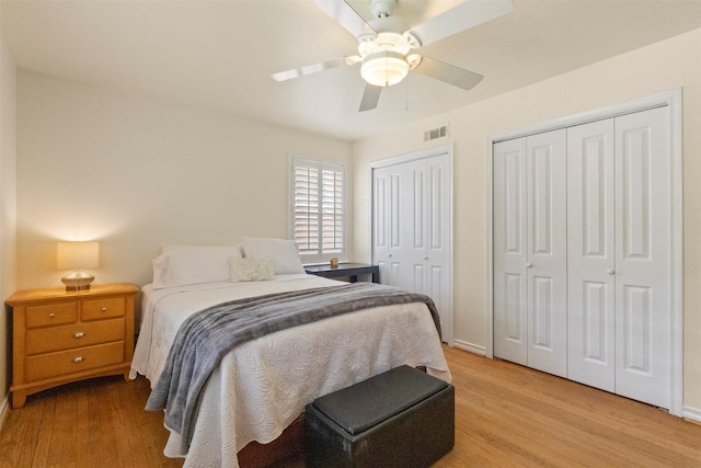 10209 Solta Dr, Dallas, TX 75218 - bedroom with multiple closets, light wood finished floors, baseboards, and ceiling fan
