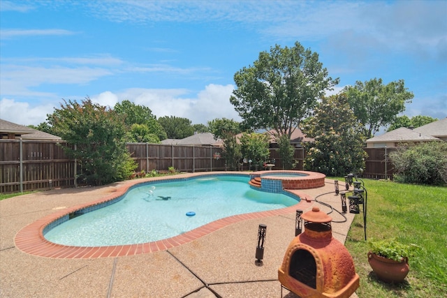 view of swimming pool featuring a patio and a pool with connected hot tub
