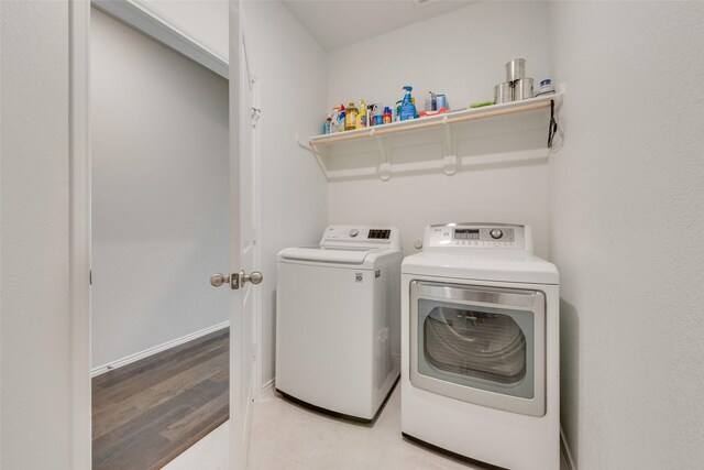 4505 Ridgehurst Ln, Fort Worth, TX 76036 - washroom featuring washing machine and clothes dryer and light wood-style flooring