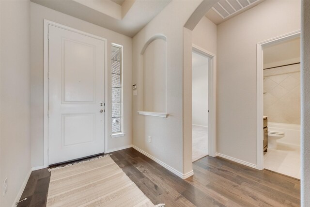 4505 Ridgehurst Ln, Fort Worth, TX 76036 - foyer featuring arched walkways, wood finished floors, and baseboards
