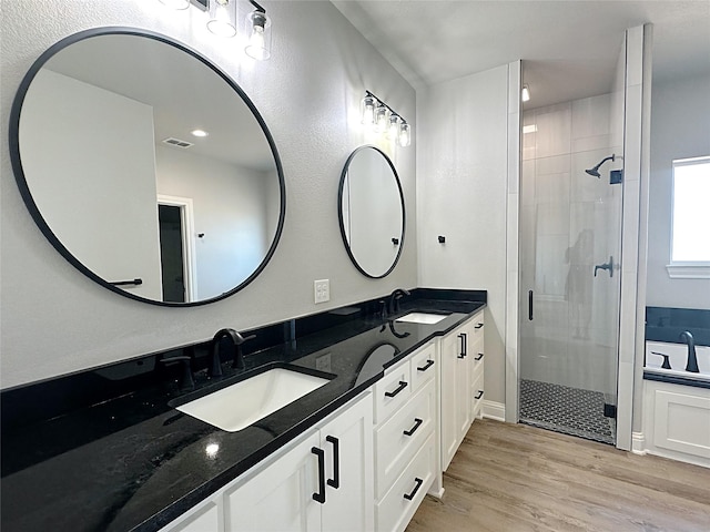 6710 Windmill Grass Ln, Abilene, TX 79606 - full bathroom featuring a stall shower, wood finished floors, and double vanity