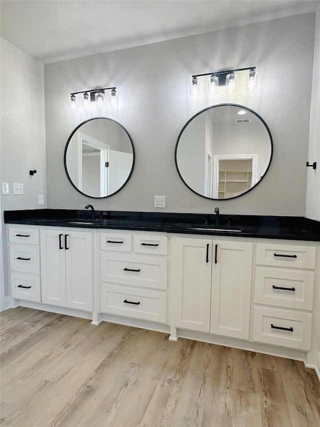 6710 Windmill Grass Ln, Abilene, TX 79606 - full bathroom featuring wood finished floors and double vanity