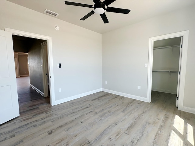 6710 Windmill Grass Ln, Abilene, TX 79606 - unfurnished bedroom featuring light wood-style floors, a spacious closet, baseboards, and a closet