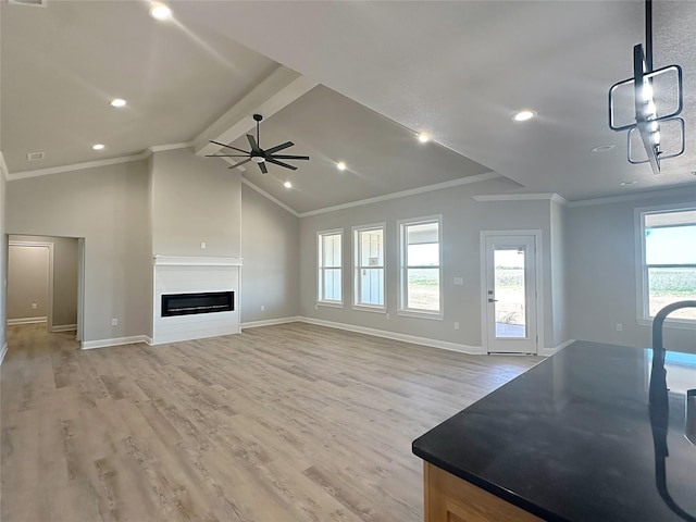 6710 Windmill Grass Ln, Abilene, TX 79606 - unfurnished living room featuring ceiling fan, light wood finished floors, ornamental molding, baseboards, and a glass covered fireplace