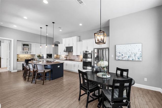 4530 Crossvine Dr, Prosper, TX 75078 - dining space featuring light wood-style floors, recessed lighting, baseboards, and a chandelier