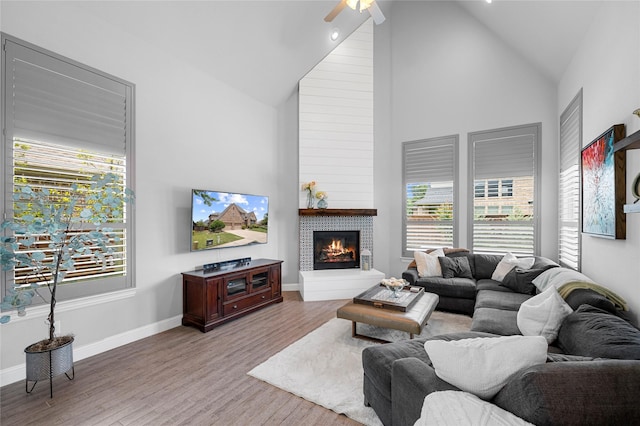4530 Crossvine Dr, Prosper, TX 75078 - living area featuring ceiling fan, high vaulted ceiling, plenty of natural light, wood finished floors, and a tile fireplace