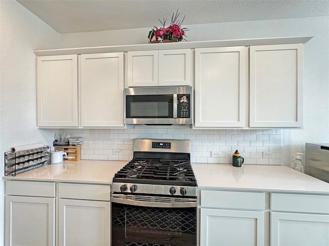 8309 Caracara Dr, Mckinney, TX 75071 - kitchen featuring stainless steel appliances, backsplash, light countertops, and white cabinets