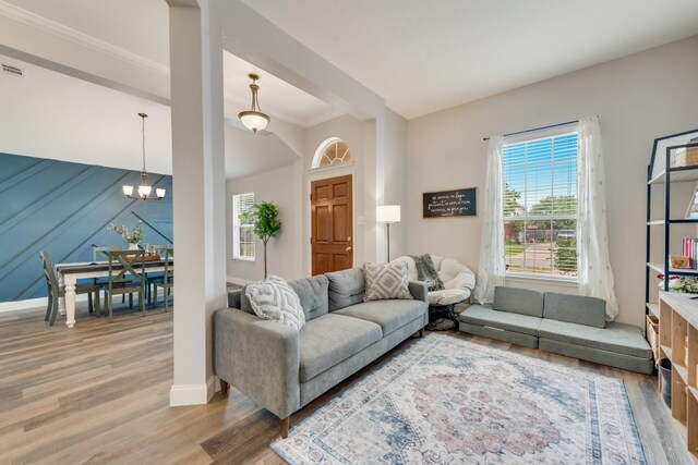 110 Redwood, Terrell, TX 75160 - living area featuring light wood finished floors, a chandelier, baseboards, and crown molding