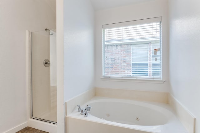 full bathroom featuring plenty of natural light, a stall shower, and a tub with jets