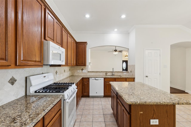 9709 Maryville Ln, Fort Worth, TX 76108 - kitchen featuring white appliances, arched walkways, a sink, light tile patterned floors, and ornamental molding