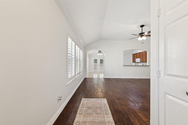 9709 Maryville Ln, Fort Worth, TX 76108 - unfurnished living room featuring a ceiling fan, dark wood-type flooring, lofted ceiling, baseboards, and crown molding