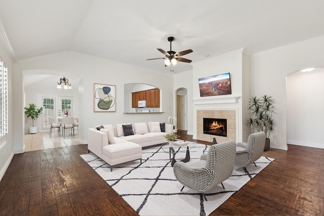 9709 Maryville Ln, Fort Worth, TX 76108 - living room featuring arched walkways, wood finished floors, a tile fireplace, ornamental molding, and baseboards