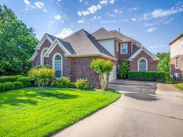 2302 Creek Crossing Dr, Corinth, TX 76210 - traditional-style house with driveway, central AC, brick siding, a front lawn, and an attached garage
