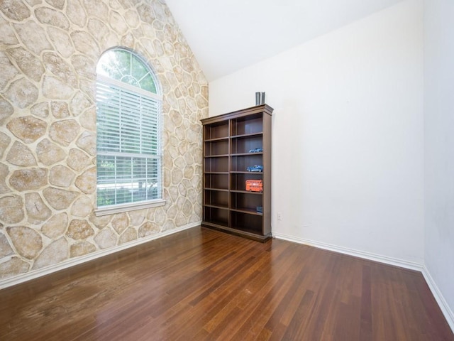 2302 Creek Crossing Dr, Corinth, TX 76210 - spare room with vaulted ceiling, wood finished floors, and baseboards