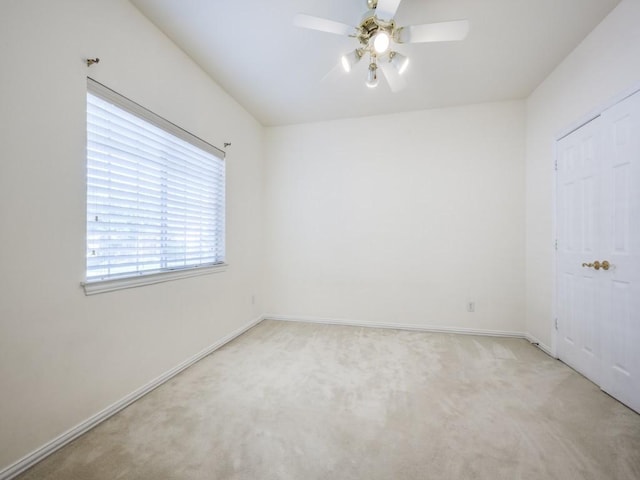 2302 Creek Crossing Dr, Corinth, TX 76210 - unfurnished bedroom with light colored carpet, baseboards, and a ceiling fan