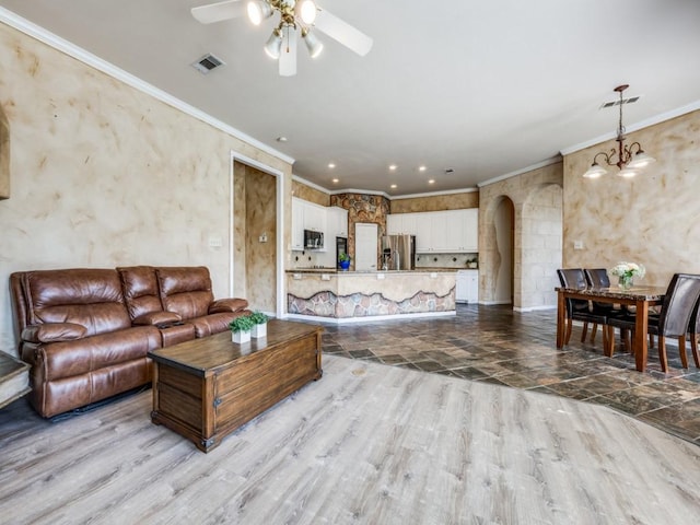 2302 Creek Crossing Dr, Corinth, TX 76210 - living area with ceiling fan, arched walkways, wood finished floors, crown molding, and a chandelier