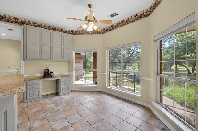 213 W Rio Rdg, Azle, TX 76020 - unfurnished office featuring healthy amount of natural light, built in desk, light tile patterned floors, and a ceiling fan