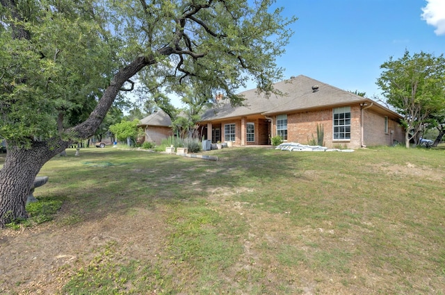 213 W Rio Rdg, Azle, TX 76020 - rear view of property featuring brick siding and a lawn