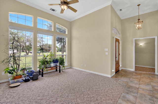 213 W Rio Rdg, Azle, TX 76020 - spare room featuring ornamental molding, ceiling fan, a chandelier, a towering ceiling, and baseboards