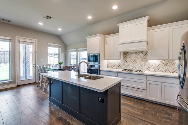 827 Esk Ave, Celina, TX 75009 - kitchen with backsplash, stainless steel appliances, light countertops, white cabinetry, and a kitchen island with sink