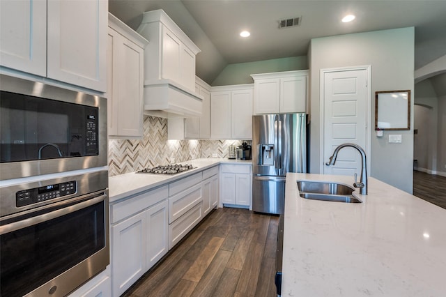 827 Esk Ave, Celina, TX 75009 - kitchen with stainless steel appliances, a sink, white cabinetry, decorative backsplash, and dark wood-type flooring
