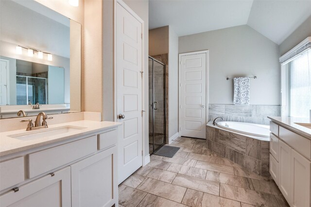 827 Esk Ave, Celina, TX 75009 - full bathroom featuring a stall shower, marble look tiles, a garden tub, vanity, and vaulted ceiling