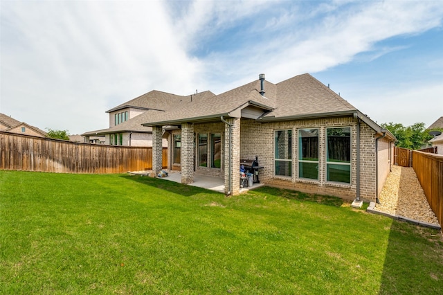 827 Esk Ave, Celina, TX 75009 - back of property featuring brick siding, a patio area, and roof with shingles