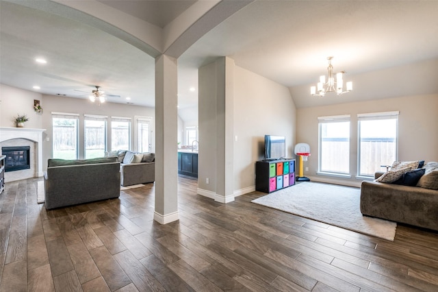 827 Esk Ave, Celina, TX 75009 - living area featuring dark wood finished floors, a fireplace, healthy amount of natural light, a chandelier, and recessed lighting