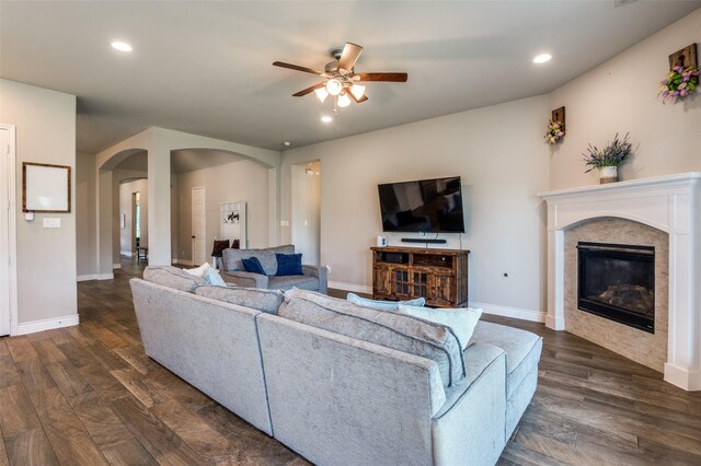 827 Esk Ave, Celina, TX 75009 - living area with arched walkways, ceiling fan, a glass covered fireplace, dark wood finished floors, and recessed lighting