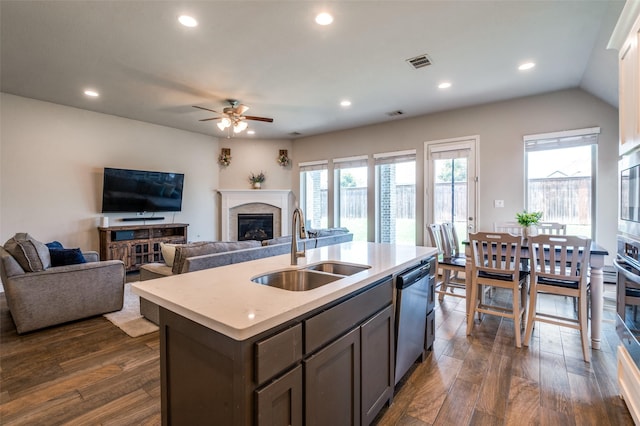 827 Esk Ave, Celina, TX 75009 - kitchen with a sink, stainless steel appliances, ceiling fan, a glass covered fireplace, and recessed lighting
