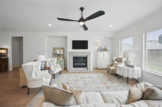513 Fieldstone Ln, Haslet, TX 76052 - living room featuring wood finished floors, ornamental molding, ceiling fan, a glass covered fireplace, and recessed lighting
