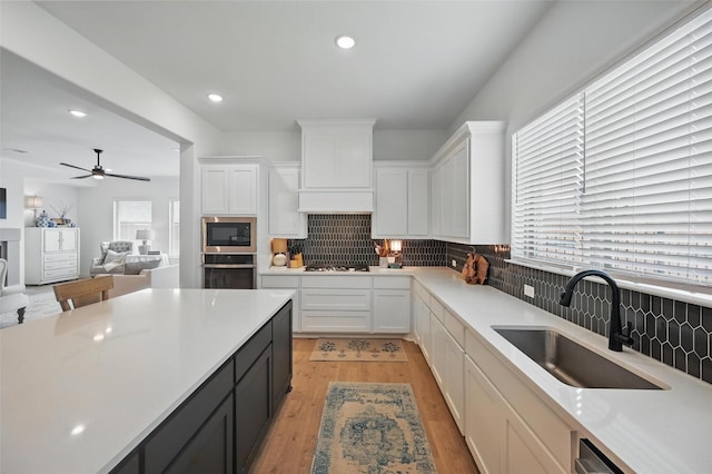 513 Fieldstone Ln, Haslet, TX 76052 - kitchen featuring a sink, stainless steel appliances, white cabinets, light countertops, and recessed lighting