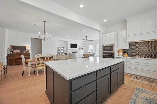 513 Fieldstone Ln, Haslet, TX 76052 - kitchen featuring stainless steel oven, built in microwave, white cabinets, light wood-style flooring, and recessed lighting