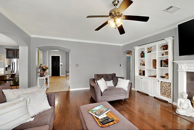 2202 Hodges Pl, Mansfield, TX 76063 - living area with arched walkways, wood finished floors, ceiling fan, crown molding, and baseboards