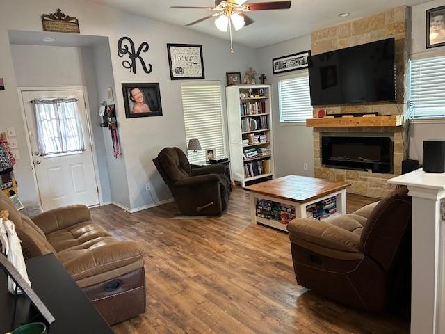 415 Magnolia, Hico, TX 76457 - living area featuring ceiling fan, a fireplace, wood finished floors, lofted ceiling, and baseboards