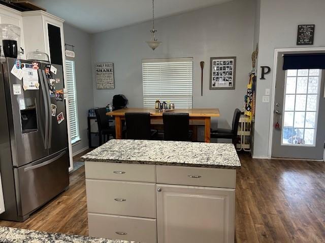 415 Magnolia, Hico, TX 76457 - kitchen with stainless steel refrigerator with ice dispenser, dark wood-style floors, white cabinetry, vaulted ceiling, and light stone counters