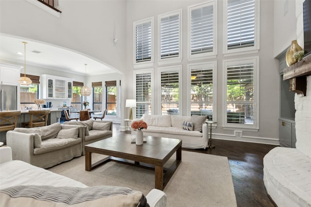 11353 Seaside Ln, Frisco, TX 75035 - living area featuring a high ceiling, wood finished floors, and arched walkways
