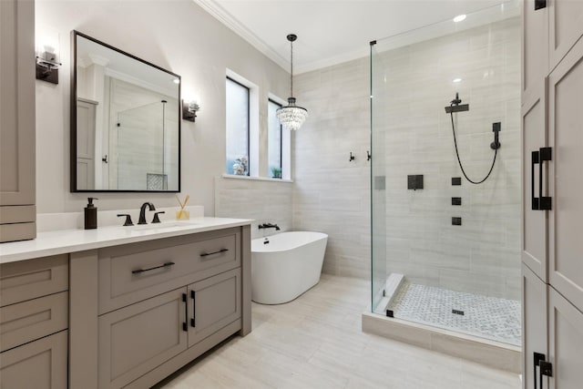 11353 Seaside Ln, Frisco, TX 75035 - bathroom featuring a shower stall, vanity, a soaking tub, ornamental molding, and tile patterned flooring