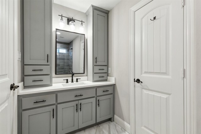 11353 Seaside Ln, Frisco, TX 75035 - bathroom featuring marble look tile flooring, vanity, a shower, and baseboards