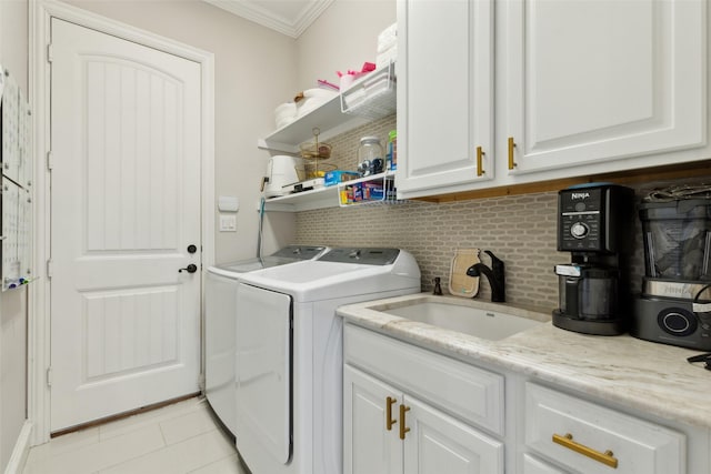 11353 Seaside Ln, Frisco, TX 75035 - laundry room featuring independent washer and dryer, ornamental molding, light tile patterned flooring, and cabinet space
