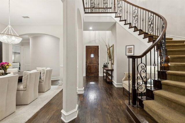 11353 Seaside Ln, Frisco, TX 75035 - foyer featuring arched walkways, wood finished floors, stairs, and a towering ceiling