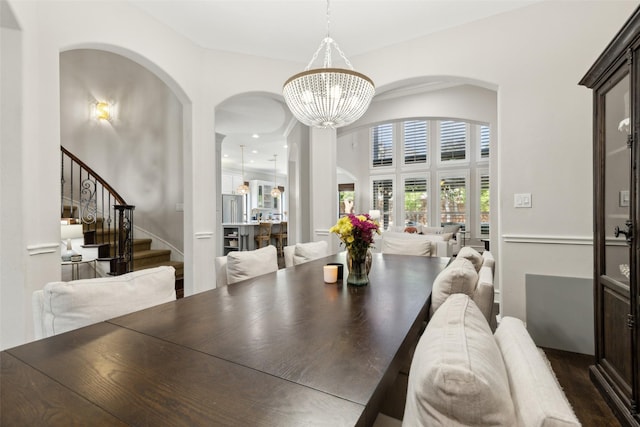 11353 Seaside Ln, Frisco, TX 75035 - dining space featuring arched walkways, a chandelier, and stairway