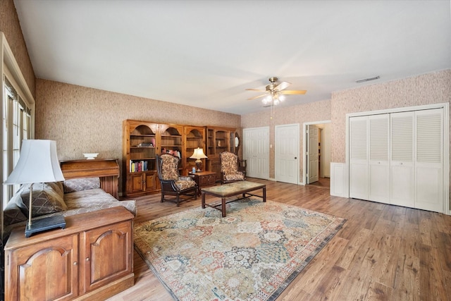 301 Peachtree St, Fairfield, TX 75840 - living area with wallpapered walls, a ceiling fan, and light wood finished floors
