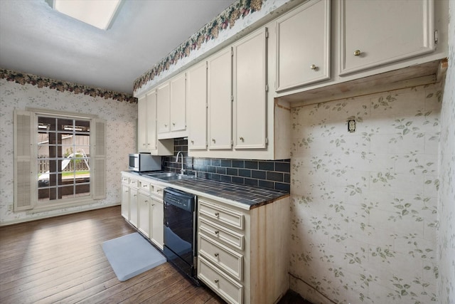 301 Peachtree St, Fairfield, TX 75840 - kitchen with black dishwasher, tile countertops, a sink, dark wood-type flooring, and wallpapered walls