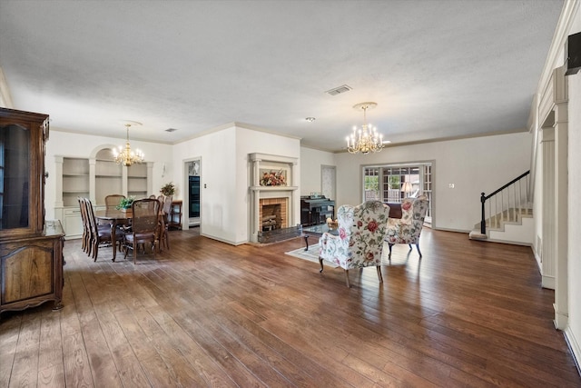 301 Peachtree St, Fairfield, TX 75840 - dining area featuring a chandelier, a fireplace, stairway, wood-type flooring, and baseboards