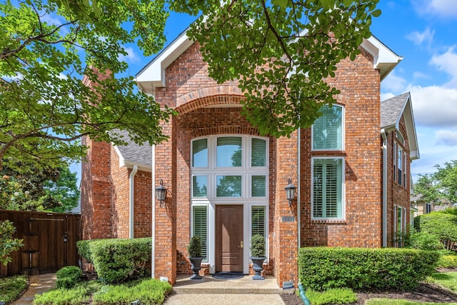 3441 Mount Vernon Way, Plano, TX 75025 - view of front of house with brick siding, roof with shingles, a chimney, and fence