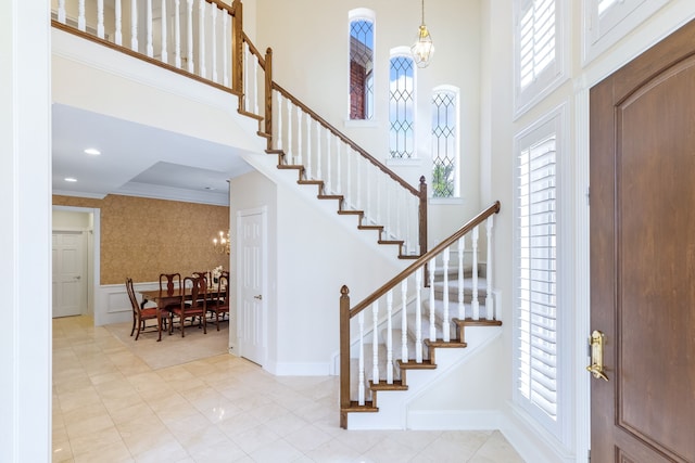 3441 Mount Vernon Way, Plano, TX 75025 - tiled foyer entrance with a chandelier, a decorative wall, healthy amount of natural light, stairs, and a high ceiling