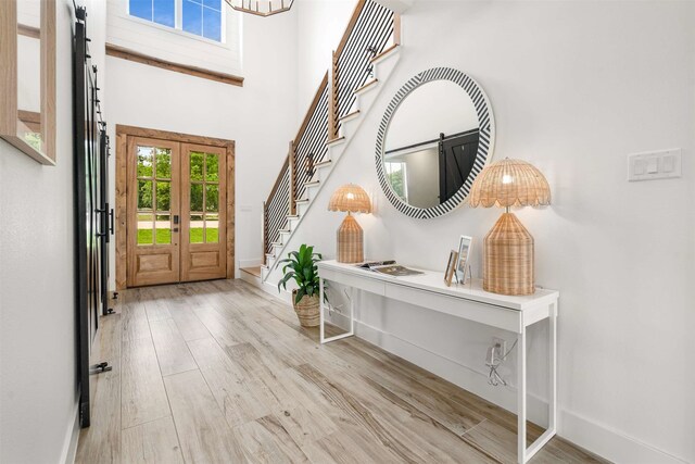 205 Oak Creek Dr, Tool, TX 75143 - foyer entrance featuring baseboards, stairs, wood finished floors, french doors, and a towering ceiling