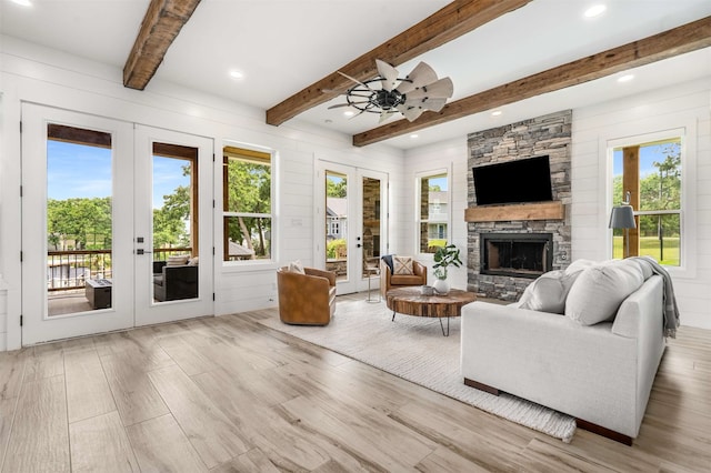 205 Oak Creek Dr, Tool, TX 75143 - living area with french doors, beam ceiling, wood finished floors, a ceiling fan, and a fireplace
